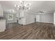 Open concept living space featuring wood-look flooring and a seamless transition into the modern kitchen at 1971 Westley Dr, Riverdale, GA 30296