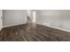 Spacious living area featuring wood-look flooring and access to stairs leading to a basement at 1971 Westley Dr, Riverdale, GA 30296