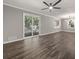 Elegant living room features wood-look floors, sliding glass doors, and modern lighting at 1971 Westley Dr, Riverdale, GA 30296