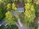 A bird's eye view shows this home surrounded by mature trees and lush greenery, offering privacy and a peaceful setting at 220 Hobnail Se Ct, Marietta, GA 30067