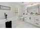 Stylish bathroom featuring a soaking tub, modern vanity, decorative fixtures and white cabinets at 220 Hobnail Se Ct, Marietta, GA 30067