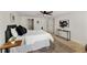 Bright bedroom featuring hardwood floors, neutral walls, ceiling fan, modern art and natural light at 220 Hobnail Se Ct, Marietta, GA 30067