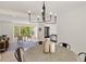 Dining area with a modern chandelier, a round table, and views into the living room at 220 Hobnail Se Ct, Marietta, GA 30067