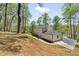 View of rear exterior and large lot of a white two-story home surrounded by mature trees at 220 Hobnail Se Ct, Marietta, GA 30067