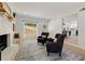 Cozy seating area with a white brick fireplace, stylish chairs, and a view into the kitchen at 220 Hobnail Se Ct, Marietta, GA 30067
