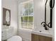 Charming powder room featuring a modern vanity, designer mirror, and natural light at 220 Hobnail Se Ct, Marietta, GA 30067