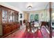 Dining room with hardwood furniture, a vintage cabinet, and a view to the backyard at 3727 Cline Se Dr, Smyrna, GA 30082