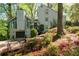 Charming home with a lush, landscaped yard, a private garage, and a wooden stairway to front door at 3727 Cline Se Dr, Smyrna, GA 30082