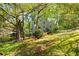 Charming home exterior with mature trees, lush landscaping, and a well-maintained lawn, creating inviting curb appeal at 3727 Cline Se Dr, Smyrna, GA 30082