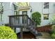 Inviting front entryway with wooden porch and stairs, landscaped yard and stone foundation at 3727 Cline Se Dr, Smyrna, GA 30082