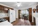 Bright kitchen featuring hardwood floor, white appliances, ample cabinets, and a small dining area at 3727 Cline Se Dr, Smyrna, GA 30082