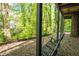 Relax on the charming porch swing, offering a peaceful retreat with views of the serene, tree-lined landscape at 3727 Cline Se Dr, Smyrna, GA 30082