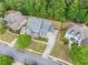 A beautiful aerial view of a home with lush landscaping, mature trees, and a well-manicured lawn at 626 Oakbourne Way, Woodstock, GA 30188
