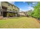 Expansive backyard with a spacious lawn, wooden fence, deck, and patio areas at 626 Oakbourne Way, Woodstock, GA 30188