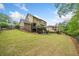 Exterior view of the home with a large, green lawn and wooden fencing at 626 Oakbourne Way, Woodstock, GA 30188