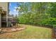 Expansive backyard features a lush lawn, mature trees, stone steps and a deck, perfect for outdoor enjoyment at 626 Oakbourne Way, Woodstock, GA 30188
