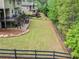 Large, fenced backyard with a well-kept lawn and multiple outdoor living spaces at 626 Oakbourne Way, Woodstock, GA 30188