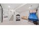 A spacious basement features a recreational area with an air hockey table, couch, and stairs to the upper level at 626 Oakbourne Way, Woodstock, GA 30188