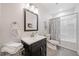 Well-lit bathroom featuring a modern vanity, framed mirror, and combined tub and shower at 626 Oakbourne Way, Woodstock, GA 30188