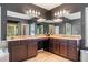 Bathroom with dual sink vanity, granite countertop, dark cabinets, and a large mirror at 626 Oakbourne Way, Woodstock, GA 30188