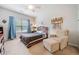 Bedroom with neutral tones, a ceiling fan, and a comfortable armchair at 626 Oakbourne Way, Woodstock, GA 30188