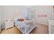 Charming bedroom with carpet, a white bed and dresser, and soft, natural lighting at 626 Oakbourne Way, Woodstock, GA 30188