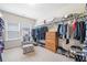 Walk-in closet with ample storage, shelving, and natural light from a window at 626 Oakbourne Way, Woodstock, GA 30188