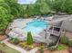 Beautiful community pool with slide and fountains, surrounded by lush landscaping and a gazebo at 626 Oakbourne Way, Woodstock, GA 30188