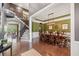 Open-concept view showcasing the dining room, staircase, and living area with beautiful hardwood flooring at 626 Oakbourne Way, Woodstock, GA 30188