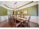 Spacious dining room with wooden table, seating for ten, stylish light fixture, and modern decor at 626 Oakbourne Way, Woodstock, GA 30188