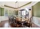 Elegant dining room features a dark wood table, seating for ten, and modern lighting at 626 Oakbourne Way, Woodstock, GA 30188
