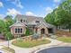 Beautiful clubhouse exterior with stone and brick, manicured landscaping, and a welcoming walkway at 626 Oakbourne Way, Woodstock, GA 30188