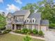 Beautiful brick two-story home with manicured lawn and attached garage in a desirable neighborhood at 626 Oakbourne Way, Woodstock, GA 30188