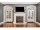 Stylish fireplace with decorative shelving on either side and a mounted television at 626 Oakbourne Way, Woodstock, GA 30188