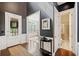 Elegant foyer with hardwood floors, a decorative table, and access to a bathroom and living area at 626 Oakbourne Way, Woodstock, GA 30188