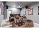 This home theater features comfortable seating, projector, and wall decor, creating an immersive entertainment experience at 626 Oakbourne Way, Woodstock, GA 30188