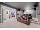 Home theater featuring a projector screen, tiered seating, carpeted floors and neutral color scheme at 626 Oakbourne Way, Woodstock, GA 30188