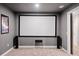 Home theater featuring a projector screen, speakers, carpeted floors, and neutral color scheme at 626 Oakbourne Way, Woodstock, GA 30188