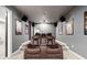 Spacious home theater room with tiered seating, projector, and speakers for an immersive entertainment experience at 626 Oakbourne Way, Woodstock, GA 30188