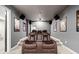Home theater with comfortable brown leather seating, projector, speakers, and movie posters at 626 Oakbourne Way, Woodstock, GA 30188