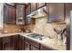 A well-equipped kitchen area featuring modern appliances and granite countertops is designed for cooking enthusiasts at 626 Oakbourne Way, Woodstock, GA 30188