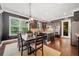 Well-lit kitchen features dark cabinetry, granite countertops, stainless appliances and adjacent dining area with natural lighting at 626 Oakbourne Way, Woodstock, GA 30188