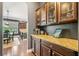 Kitchen area with granite countertops, a coffee bar, and glassware cabinets creates an inviting space at 626 Oakbourne Way, Woodstock, GA 30188