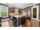Spacious kitchen featuring stainless steel appliances, central island and sleek dark cabinetry perfect for cooking at 626 Oakbourne Way, Woodstock, GA 30188