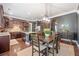 Open-concept kitchen with stainless steel appliances, dark wood cabinets, and dining area perfect for gatherings at 626 Oakbourne Way, Woodstock, GA 30188