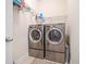 Laundry room featuring a washer and dryer, shelves, and neutral color scheme at 626 Oakbourne Way, Woodstock, GA 30188