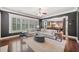 Bright living room featuring hardwood floors, large windows, neutral furnishings, and an open floor plan at 626 Oakbourne Way, Woodstock, GA 30188
