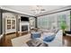 Cozy living room with fireplace, built-in shelving, hardwood floors, and ample natural light at 626 Oakbourne Way, Woodstock, GA 30188