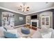 Inviting living room features a fireplace, white built-ins, and comfortable seating with ample natural light at 626 Oakbourne Way, Woodstock, GA 30188