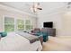 Bright main bedroom features tray ceiling, sitting area, and large windows for ample natural light at 626 Oakbourne Way, Woodstock, GA 30188